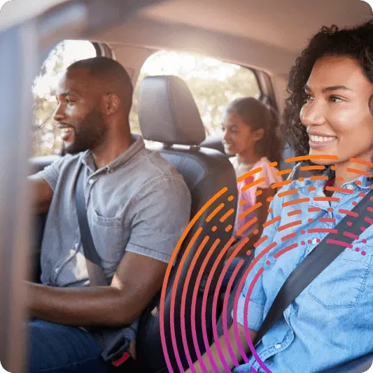 Happy family in a car smiling